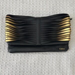 Bebe Black and Gold Wave Clutch